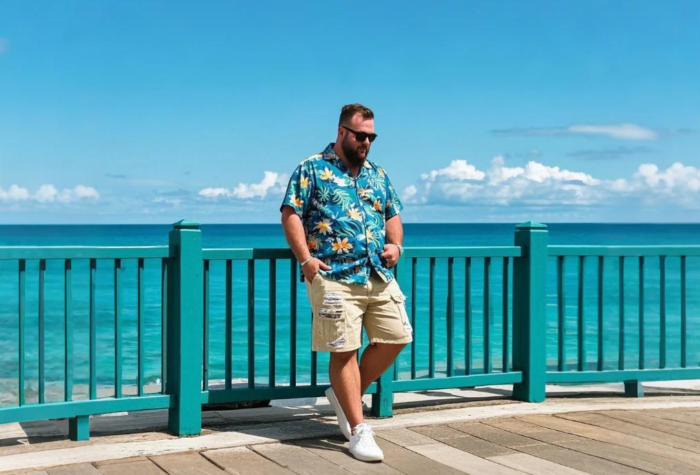 A man staying on the seaside in big men's shorts