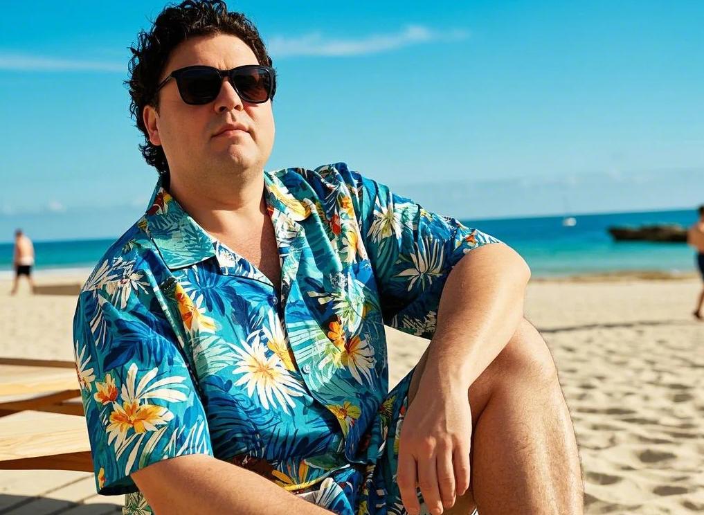 A big and tall man in relaxed Hawaiian shirts