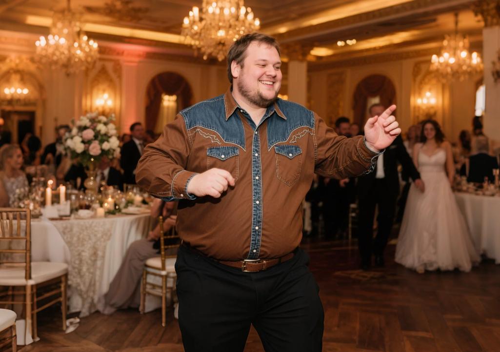 A big and tall man dancing in fitted-cut Western shirts