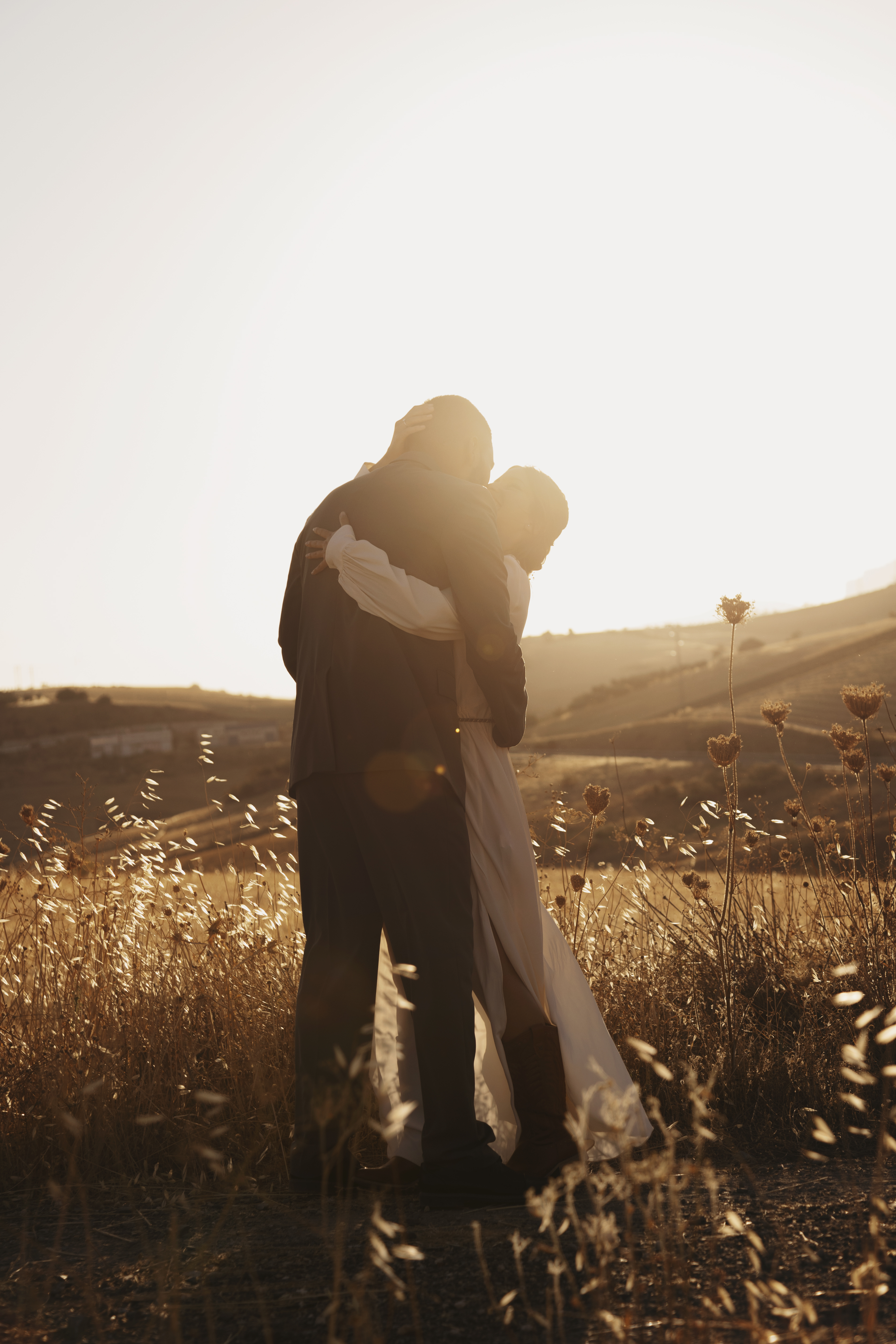 Married couple holding each other tightly, a song from Ed Sheeran, beautiful necklace for couple, wedding gift.